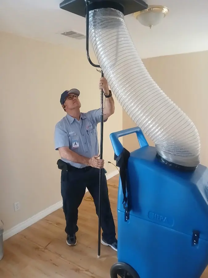 Furnace Tune-Up technician using HEPA equipment in Greenville